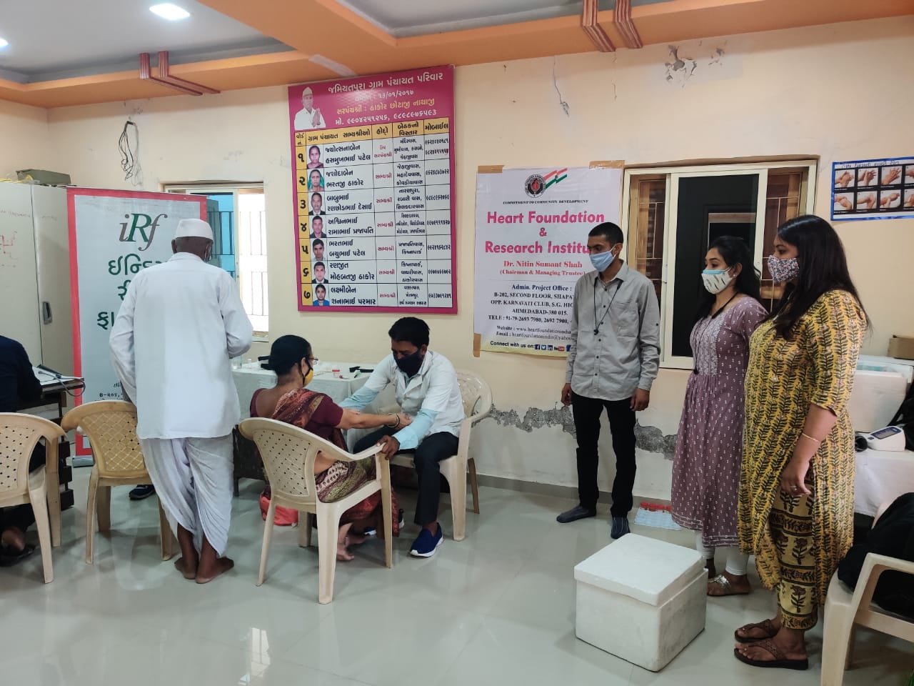A doctor checking a participant's blood pressure at a Macsys Life Science health camp